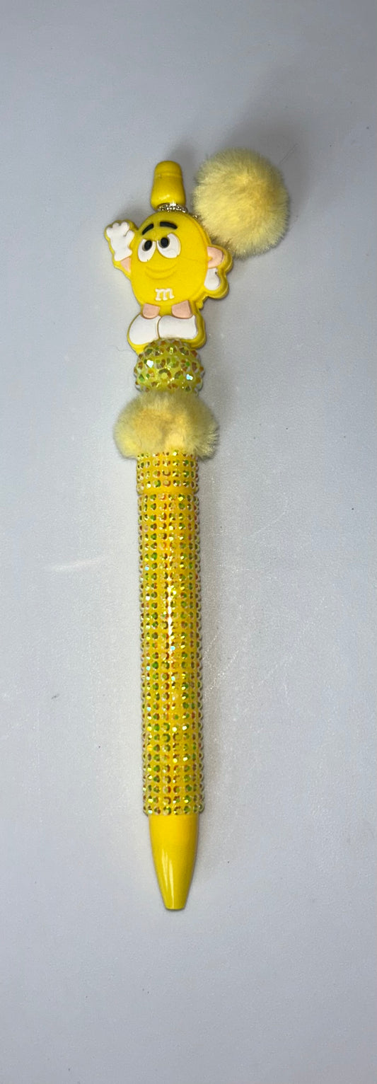 Decorative pen with a yellow M & M  top 